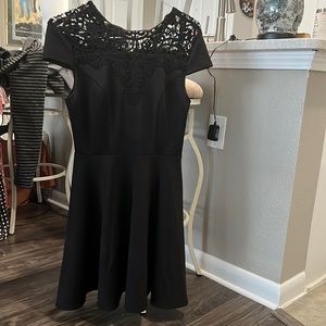 Waisted black dress with lace on top of front and back.